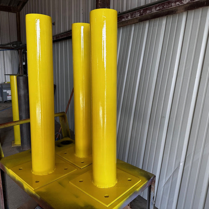 Finished bolt-down bollards fabricated by Dark Horse Metals